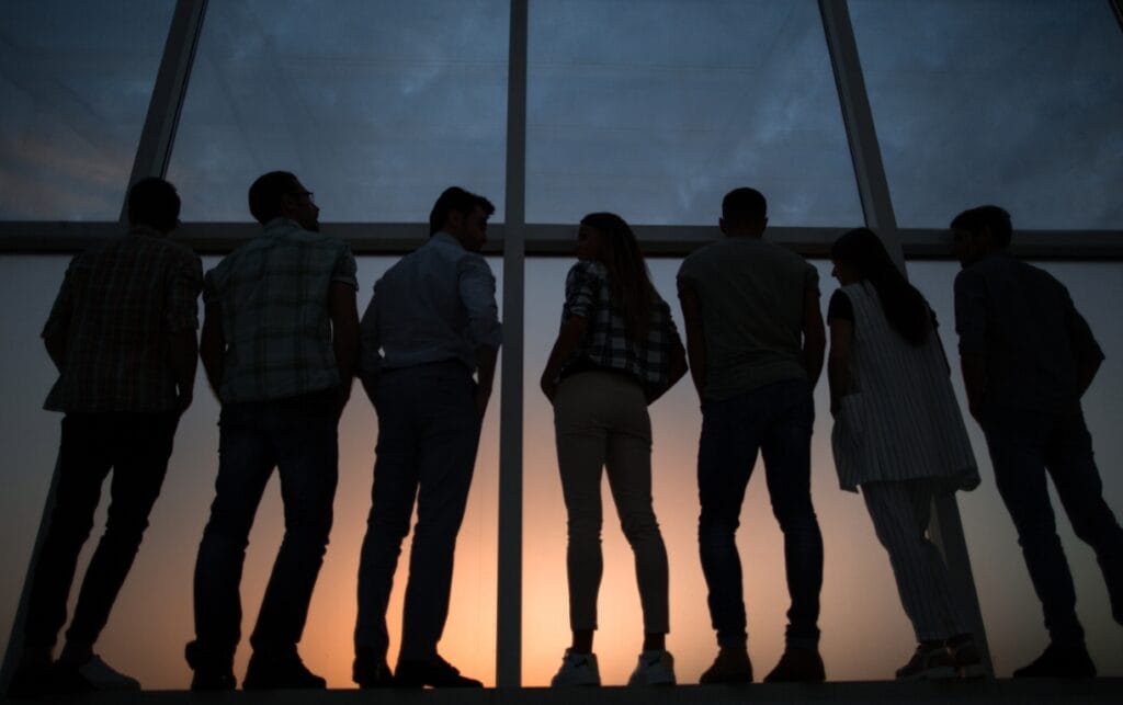 in full growth.modern business team standing near a large window.the concept of teamwork
