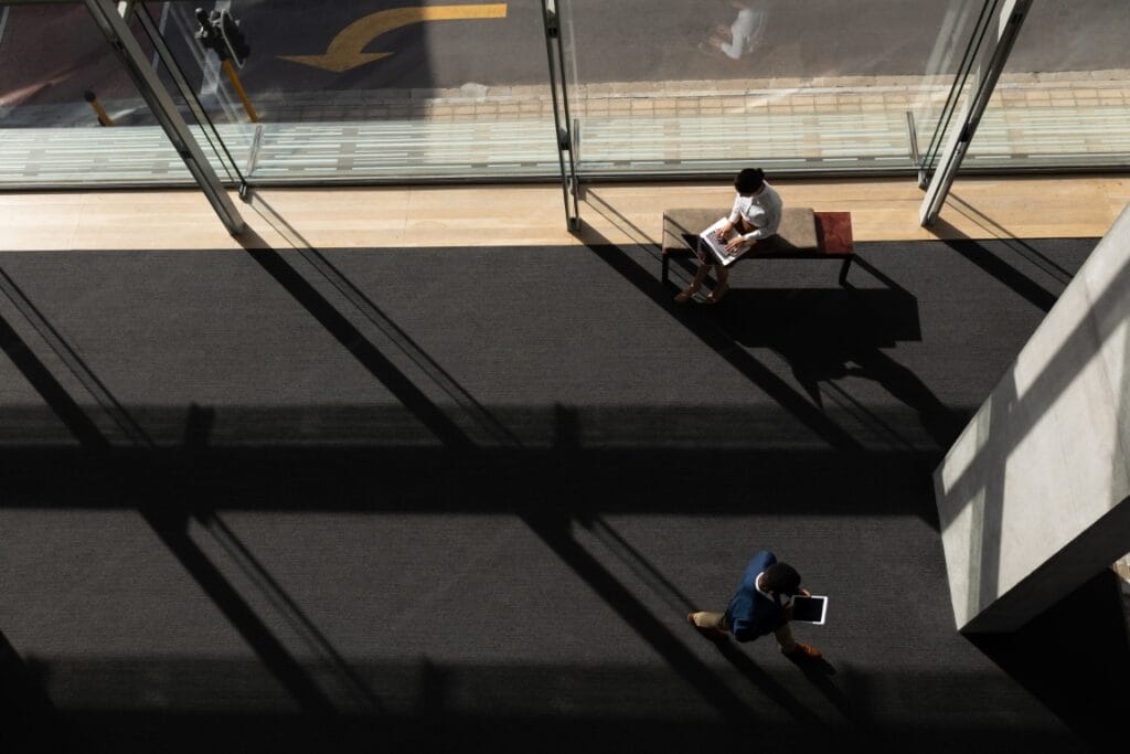 High angle view of young multi-ethnic business executive using multimedia devices in modern office